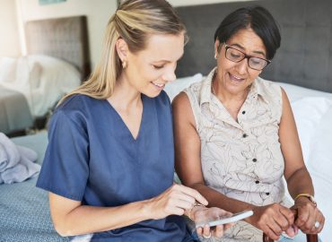 Happy woman, nurse and phone in elderly care for consultation, support or healthcare diagnosis at h